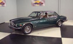 Stk#004 1985 Jaguar XJ6 - Series 3 Exterior: Green with gold pin stripe, real wire wheels, Black body side molding, front & rear bumpers, grill, mirrors, door handles, luggage rack, head lights and tail lights, emblems, and side marker lights are all