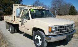 1991 Chevy C-3500 dump. This truck came from the Dept. of Natural Recourses and only has 56,000 miles on it. It has a 5.7L engine and automatic transmission. The lift is an electric over hydraulic unit. The bed has a steel floor that look like it has