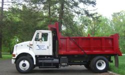 1995 International dump truck, white cab, red dump body. Truck purchased from Beltway International in 2005 with a rebuilt M11 Cummins Turbo diesel, a fresh professionally installed dump body, and a rear end overhauled by E&M machinery Inc. 9 Speed