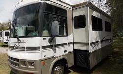 2002 Winnebago Adventurer, Class A Gas, Model 35U, with 2 Slides, and Low, Low Miles. The two slides are located in the Dinette/coach STORE MORE Slide Out-System, and the Rear Bed/Wardrobe Slide Out with large vanity and built in TV. Ford Powered