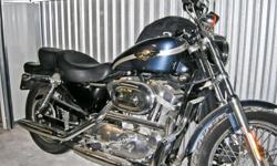 &nbsp;
This 2003 H-D Sportster in Gunmetal Blue metallic was purchased in April '04 with 3,690 miles on it. I put approximately 200 miles on it before I left for the Middle East. The motorcycle was prepared for storage (battery removed, fluids drained)