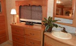 2006 Keystone Montana Fifth Wheel, desert sunset interior decor. Has granite kitchen countertop with matching sink covers. 3 slide outs, with tons of storage. King bed in bedroom with underbed storage area. Room & hookups for washer/dryer. Computer center