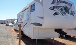 Great high end Keystone 5th wheel. This is a 4 seasons trailer with the popular rear kitchen. GREAT FOR COOL WEATHER CAMPING, HUNTING OR SNOWBIRDS! It has 2 slide outs with a QUEEN SERTA mattress in the bedroom slide out. There is a wardrobe that goes