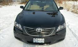 2007 Toyota Camry Hybrid. This little car has all the options, like On star, tile wheel, with radio controls, 6 disc CD changer, power windows, power locks, AC with climate controls, blue tooth phone through the radio and 35,000 miles. And all that with