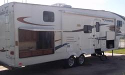 This is a 2011 Coachmen Chaparral 269 BHS 5th wheel with a 14' slide-out and a separate room in the rear with 3 bunks and a wardrobe. This model also has an external kitchen with a fridge, sink and grill hook up. It is loaded with features such as a