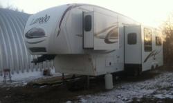 Keystone Laredo 33ft long, Original owner, 3 slide outs, sleeps up to 8, master bedroom/bathroom, rear bunks with a half bath in the rear of the camper. Living room area has a 32in flat screen tv, stereo, dvd player, love seat and kitchen table both turn