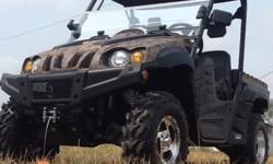 This 700cc side-by-side is the perfect vehicle for farmers or hunters looking for a hard working machine. Fuel injected, 2WD, 4WD, hi/low transmission, locking differential, dump bed, complete with remote controlled winch. Windshield, roof, doors,