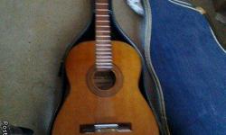 This is a beautiful, mahagony acoustic guitar in excellent playing condition with pristine guitar case and a few pieces of sheet music, also has an electric tuner.&nbsp; This guitar has been handled with great care and is in GREAT condition. &nbsp;Comes