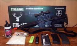 Stag Arms M4 Commando air soft gun with semi/full auto fire, adjustable stock, and adjustable sights. Selling it with a red/green dot scope, adjustable strap, one 100 round magazine, one 300 round magazine, one magazine speed loader, one battery