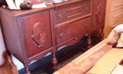 6 ft. solid wood buffet table. Dark in color, distressed finish. Two side doors and two drawers. Must see to appreciate. Could be refinished. Local inquiries only, cash only.
