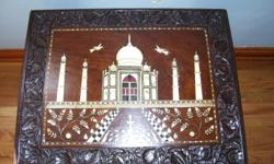 Antique dark wood Indian end table. Came from India in the 1940's. Carved wood and mother of pearl inlay depicting Taj Mahal. Elephant legs with Ivory Tusk. Excellent condition. Call 419-289-6674 any time before 10 p.m.