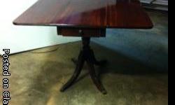 drop leaf table in excellent condition, reeded edge and reeded legs with cast brass hairy paw casters.