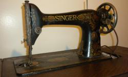 Antique Singer Treadle Sewing Machine in excellent condition. Original operating manual included. Comes with original Buttonholer in case with instruction booklet. Detail on machine is exquisite. This item is a "must have" for the collector or anyone with