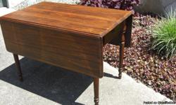 Beautiful solid walnut drop leaf table with two end drawers. Taken care of and loved by a single owner. Purchased new in 1934. The dimensions with the leaves extended are 54" x 44", with the leaves closed 27" x 44", it is 30 1/2" high.
This antique table