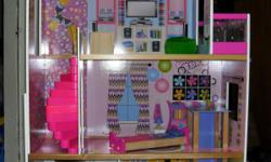 4FT Tall 3 storys it has a working elevator, comes with some doll furniture in excellent condition. My grand daughter won a new doll house from Barbie,com. Call for more information 863-381-1839