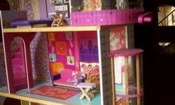 This is a 3 story wood barbie house with elevator and stairs. It is the Bright pink dream house disco tech style. Furniture included. The house is in great shape, like new. The same house retails in stores for $120+.