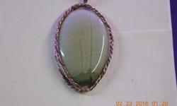 Handmade 28in sterling silver and copper woven oval frame with large sterling chain bail.
The cabochon is hand cut 28x42mm and one of a kind gorgeous agate in a light green.
The agate has a picture of two trees and a mountain in the back ground in
