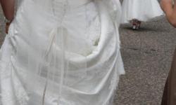 Gorgeous A line wedding gown size 20 with lace aplique, champange corsett back and accent in front, short train, already bustled and was professionaly cleaned in put in preservation box, opptional pearl accent fingertip veil, underslip for extra poof, and