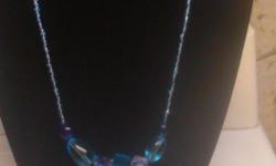 Hand crafted blue glass bead necklace has over 100+ beads to give it that sparkle and 7 medium sized beads for that perfect wow affect. Its medium sized so its centered in the middle of your chest.