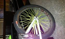 Custom BMX bike, sputnic frame, custom lime green spokes in back wheel. Bronze handle, lime green handles, frame silver.