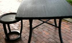 Im selling a brand new NEVER used&nbsp;patio table and matching side tabe.&nbsp; Beautiful dark woven wood.&nbsp; Side tabe has frosted glass inlay with leaf detail. LOVE this set just have no room for it since we moved.