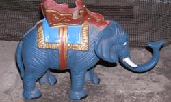 CAST IRON ELEPHANT COIN BANK
Pre-Owned
Cool collectible Elephant Coin Bank, just insert a coin in the trunk of the Elephant and pull up on the tail and the trunk shoots the coin into the top of the bank. The trunk has to be pulled down till it locks in