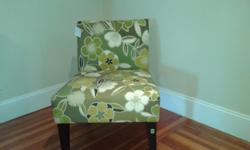 Green floral print with cream and brown acccent chair with brown legs and no arms...