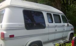 White Van in good shape with captain seats.Back seat lays down to a bed, Wine inter.,TV is small,New DVD player, radio, Brand new starter, Tires in good shape. 350 motor V8. miles on van is 86659.1 right now. Buy as is.