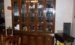 Burl wood, beveled glass inside and out. Shelves and drawers behind bottom doors, lighted. Very nice. Please call 561-776-2000. Only before 9:00 pm.