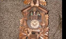 This Black Forest cuckoo clock has animated dancers; deer head w/horns; hanging animals; cast iron pine cone weights; plays music on the half hour with two different tunes&nbsp;(can also be silenced); pendulum; extensively hand carved with oak leaves,