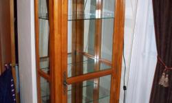 Two(2) matching Curio Cabinets for sale. EXCELLENT / Like new condition! Each cabinet measures 82" high x 25" wide x 13" deep. Golden oak wood finish. Beautiful detailing. Full length mirrored back. Each with four(4) adjustable glass shelves. Accent
