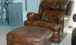 &nbsp;
Cushy Brown Leather Chair with Ottoman. $100.00 for both pieces.
Good condition. Classic style. Brass color tack trim. Extremely Comfortable.