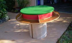 two level circular game table will seat 6. covered in green