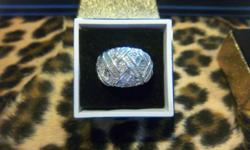 This 10WGold dome ring features approx. 2ctw Diamond baguettes and rounds bezel and pave' set in a criss cross patterns across the top. The diamonds are approx. I clarity with approx. G-I color this ring weighs approx. 8.1 grams and is a size 7. I will