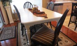 Broyhill - cream dining room table - 68x44 with two leaves.&nbsp; Will seat 12 people.&nbsp; Chairs black wood with black striped fabric seats.&nbsp; Perfect condition.&nbsp;
Also, 2 countertop bar stools, black with red tied on fabric seats.&nbsp;