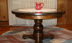 Solid dark walnut wood table 48 inches round, with removable leaf extends to 60 inches. Has large barrel pedestal. Four matching captains chairs. Excellent condition. May be seen in Northfield, New Jersey,minutes from Atlantic City. Please contact at