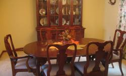 Lovely dark wood oval dining room table that extends to 78x44. Six chairs including 2 with side arms. Hutch includes 2 shelves on the bottom and 3 wooden doors. Top includes 3 shelves with glass doors. Also includes divided cutlery drawer and dinnerware