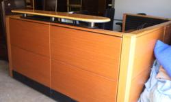This is a VERY nice receptionist desk.
The finish is recut Mahogany
It is 6'7" x 6'7"
Panels 40" tall, the counter 44" tall