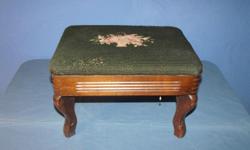 A wonderful antique footstool, circa mid to late 19th century. Green embrodered top shows obvious wear but overall it is in good condition. The wood is believed to be walnut and close examination shows signs of hand sawing marks. Wood also shows signs of