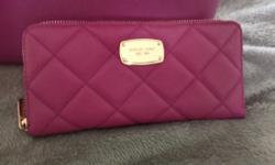 This genuine Michael Kors purse and wallet will get the compliments! Only 4 months old, excellent condition. The color us a Raspberry/fushia. Both are all leather and even though they don't look like the same color because of the light, there are a