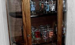 A NICE GLASS CABINET WITH A MIRROR STRIP ON TOP. IT HAS 2 SHELVES PLUS THE BOTTOM SHELF. GREAT TO DISPLAY ALL YOUR TREASURES.