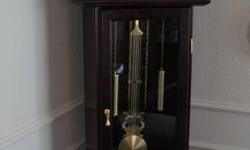 Walnut finished 77" tall Grandfather Clock, very good condition.