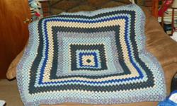 Granny Square Afghan 5' by 5' , handmade in shades blue and ecru. &nbsp;Black trimmed afghan 5 1/2' by 6', each afghan is $500.00.