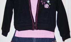 HOODED JACKET & DENIM SKORT SET (3 PC)&nbsp;outfit is 60% cotton, 40% polyester. It features a black hooded jacket with pink stitching and floral embroidery on the front. It zips up, and has pockets on each side. The coordinated pink top has matching