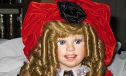 Joy is a porcelain doll from the Hamilton Collection, sculpted by Ute Kase-Lepp. She is very large, 25 inches tall, and is dressed all in red for the holidays, She comes with her songbook, hat, Certificate of Authenticity, stand, and original box.
Joy is