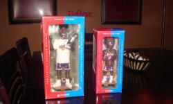 Kobe with lakers uniform and basketball in hands Shaq with trophy and championship shirt.They are both in theire original boxes never been opened.