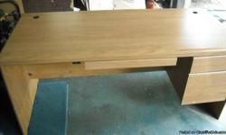 this large wood desk is in good condition has holes on each end of the desk to put cords thru for a computer or other office machines.