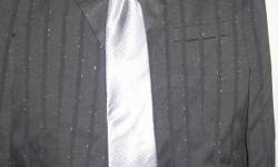 This is a Mans Black formal suit with a fine silver pin stripe. Comes with matching silver tie. Suit worn one and we paid 400.00