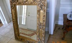 Elegant mirror to add your home. The description is 51 1/2" x 39 1/2" which could be either way. The gold accent is 8" wide. It was once in a model show house.