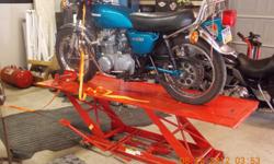 Drive on motorcycle lift hydraulic lift holds up to 1000 pounds only used 2 times to restore a bike. --